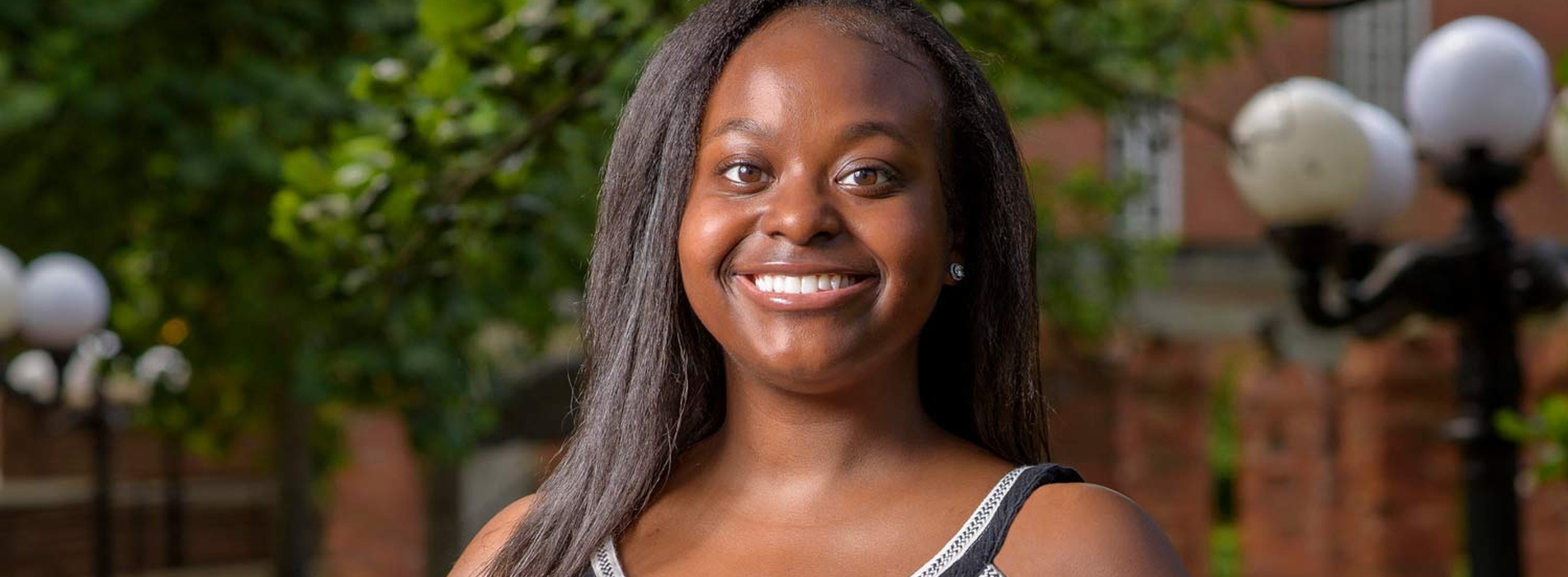 A young woman wearing a black shirt smiling.